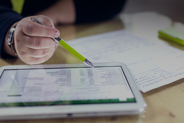 Person reviewing data on mobile tablet device