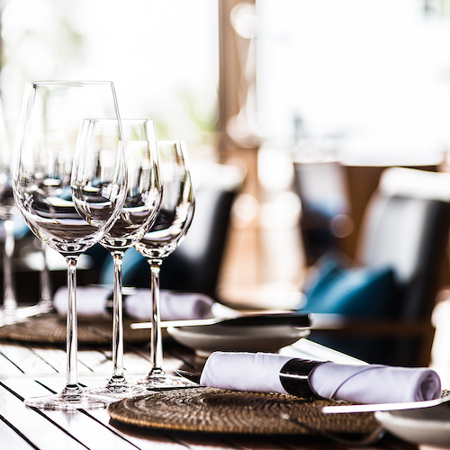 Selective,Soft,Focus,On,Wine,Glass,On,Dining,Table,In Restaurant table setting
