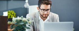 Man using laptop to manage deputyship operations