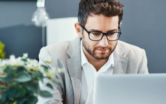 Man using laptop to manage deputyship operations