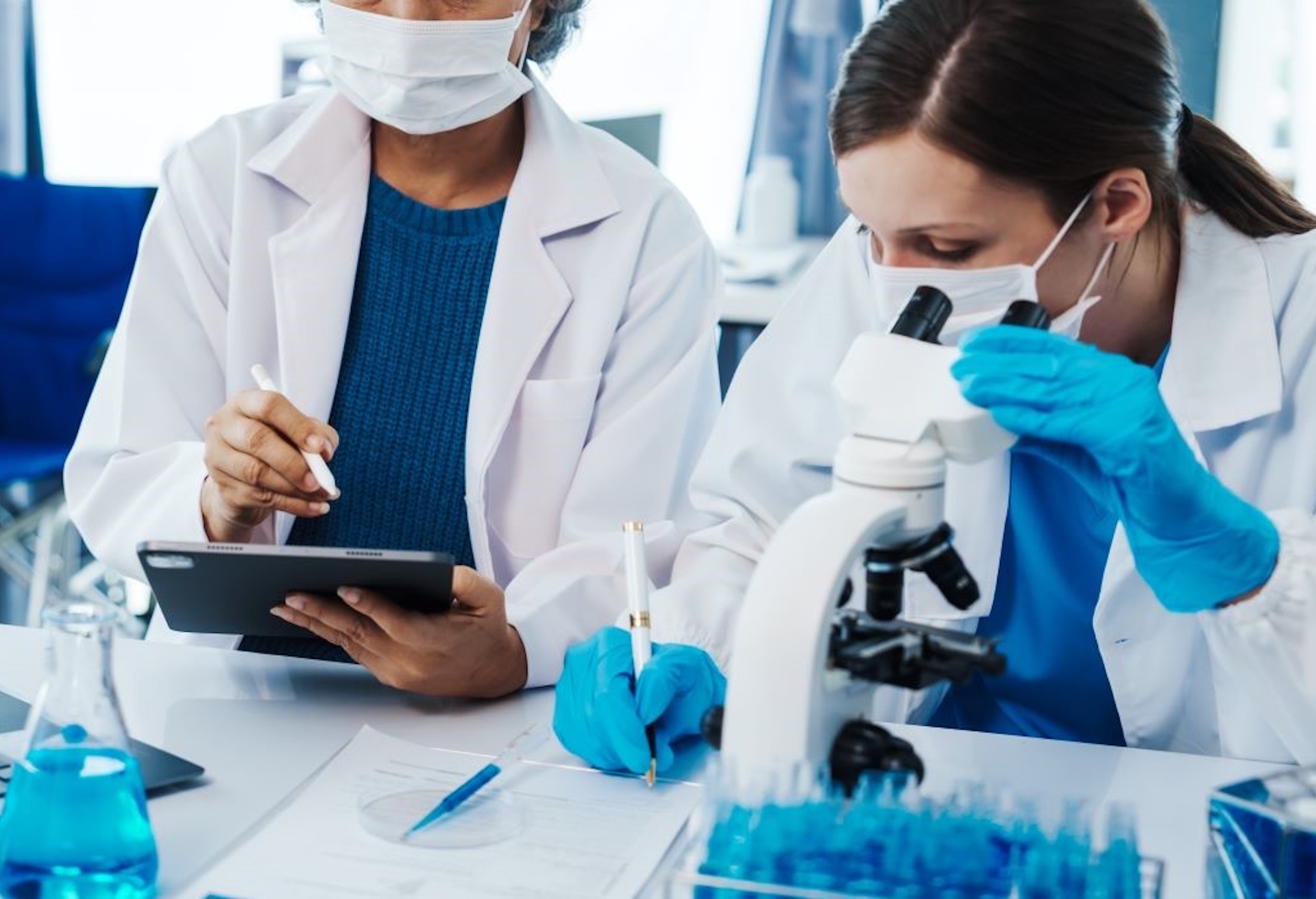 Idox Lilie Sexual Health Software Two Clinical Team Members with laptop and microscope