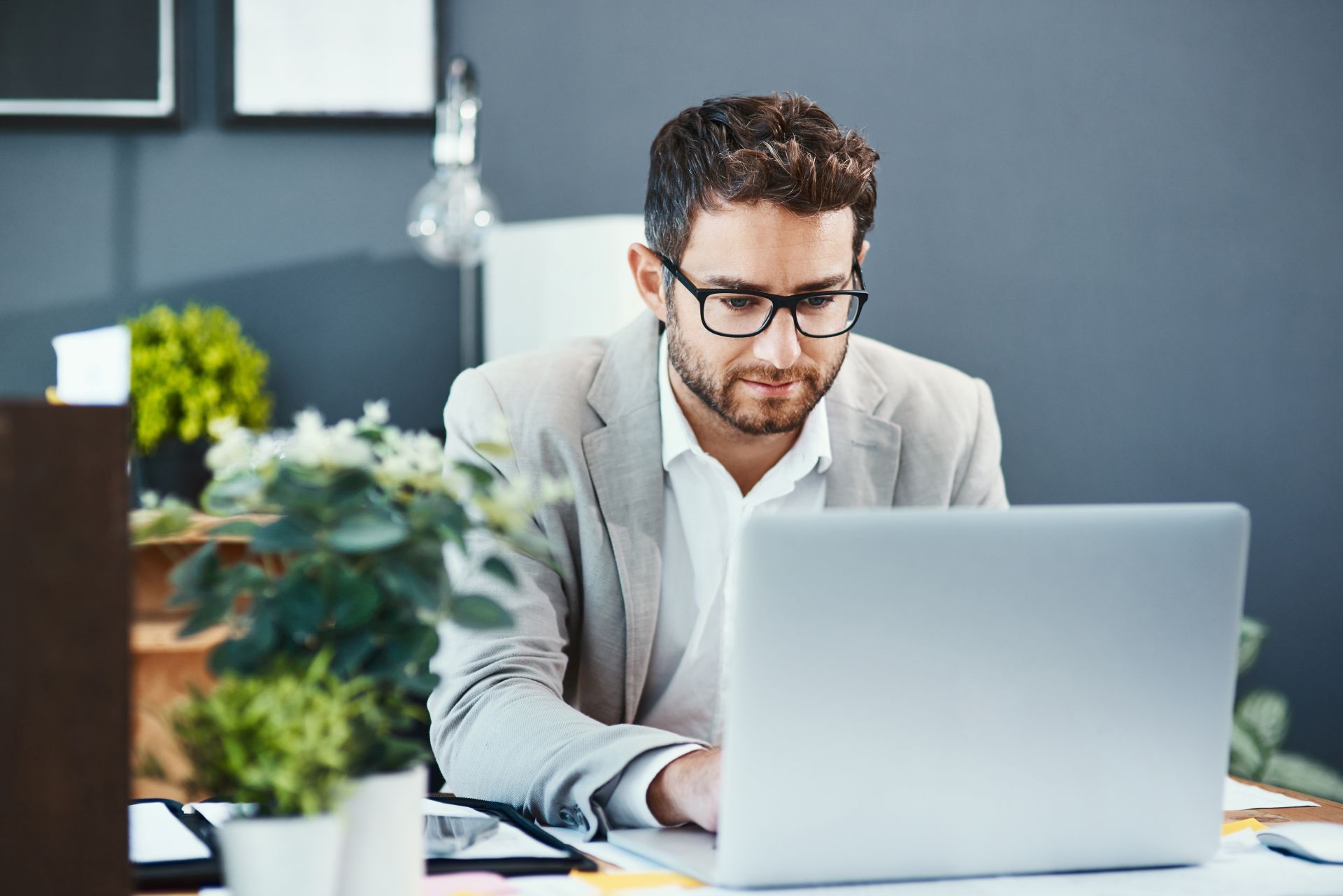 Idox_CasparLaw_Business_Meeting_Man_On_Laptop