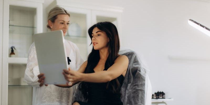 Cosmetologist consulting with a client