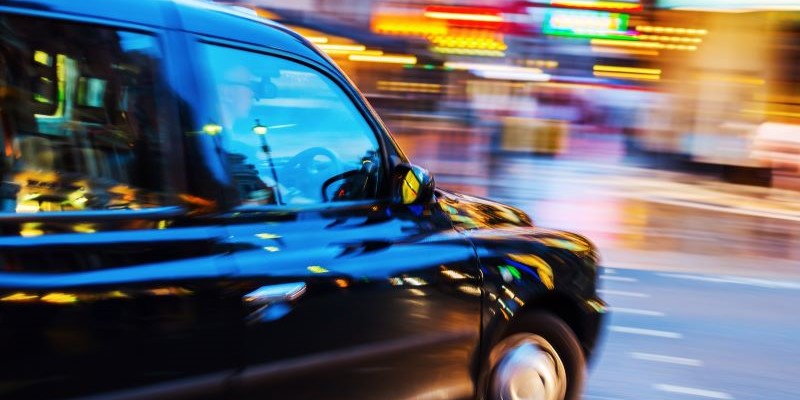 London Taxi in night traffic with abstract motion blur