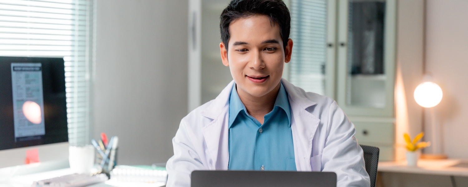 Lilie-SexualHealthSoftware-Clinicial-leads Lilie-SexualHealthSoftware-Clinician-in-office-facing-laptop