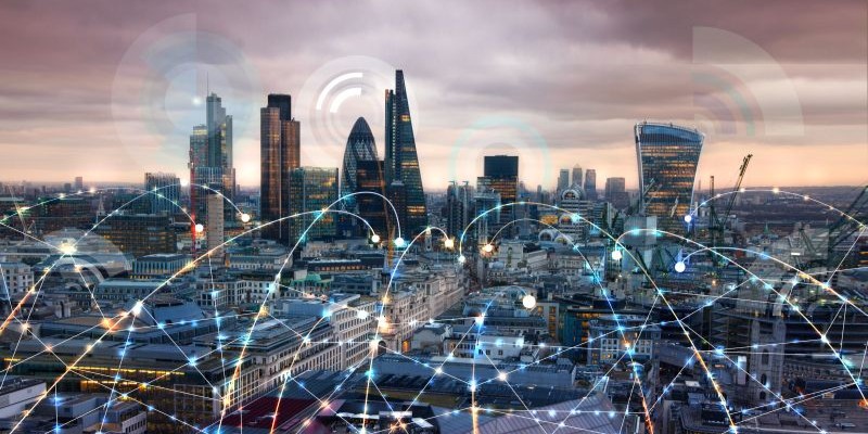 City of London at sunset with communication icons and network lines