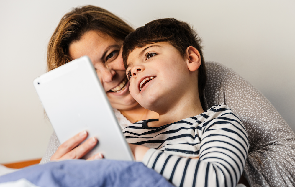 Why-invest-in-the-internet-of-things Housing association, mother and child smiling looking at tablet