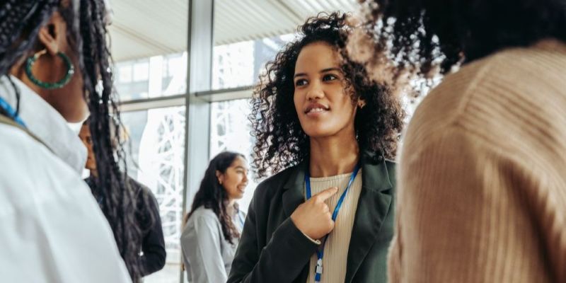 A lively conference scene showcasing diverse professionals immersed in interaction and exchange, highlighting networking and meaningful communication.