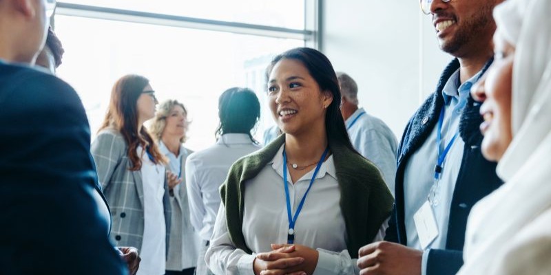 Group of diverse business professionals, businessmen and businesswomen, networking at a conference event.