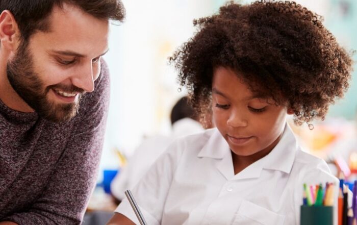 EHC Hub teacher providing one-to-one support to a primary school pupil in a classroom, representing SEND education.